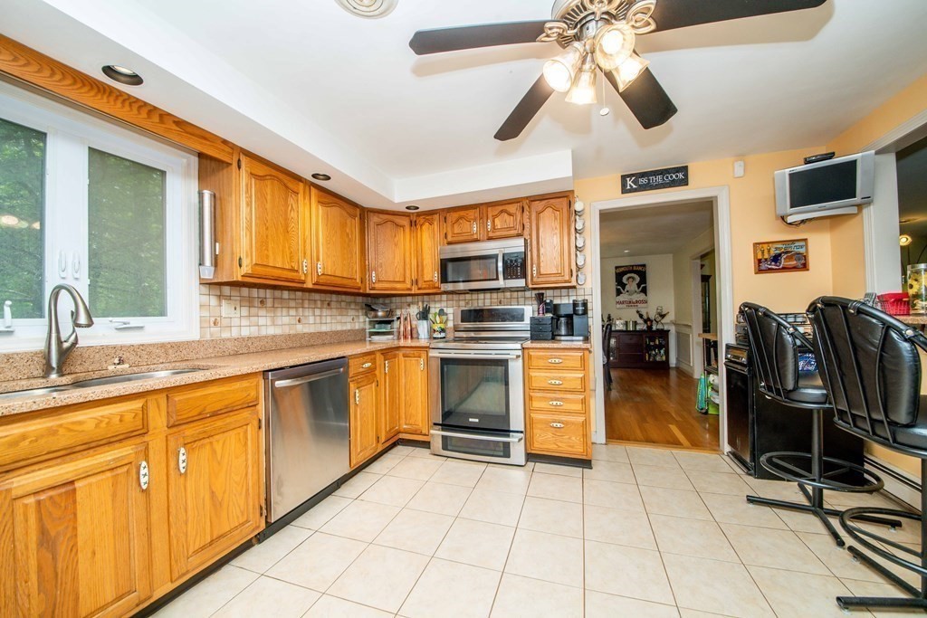 5 Chief Lane Canton, MA 02021 - Photo 9 of 42 a kitchen with cabinets and wooden floor