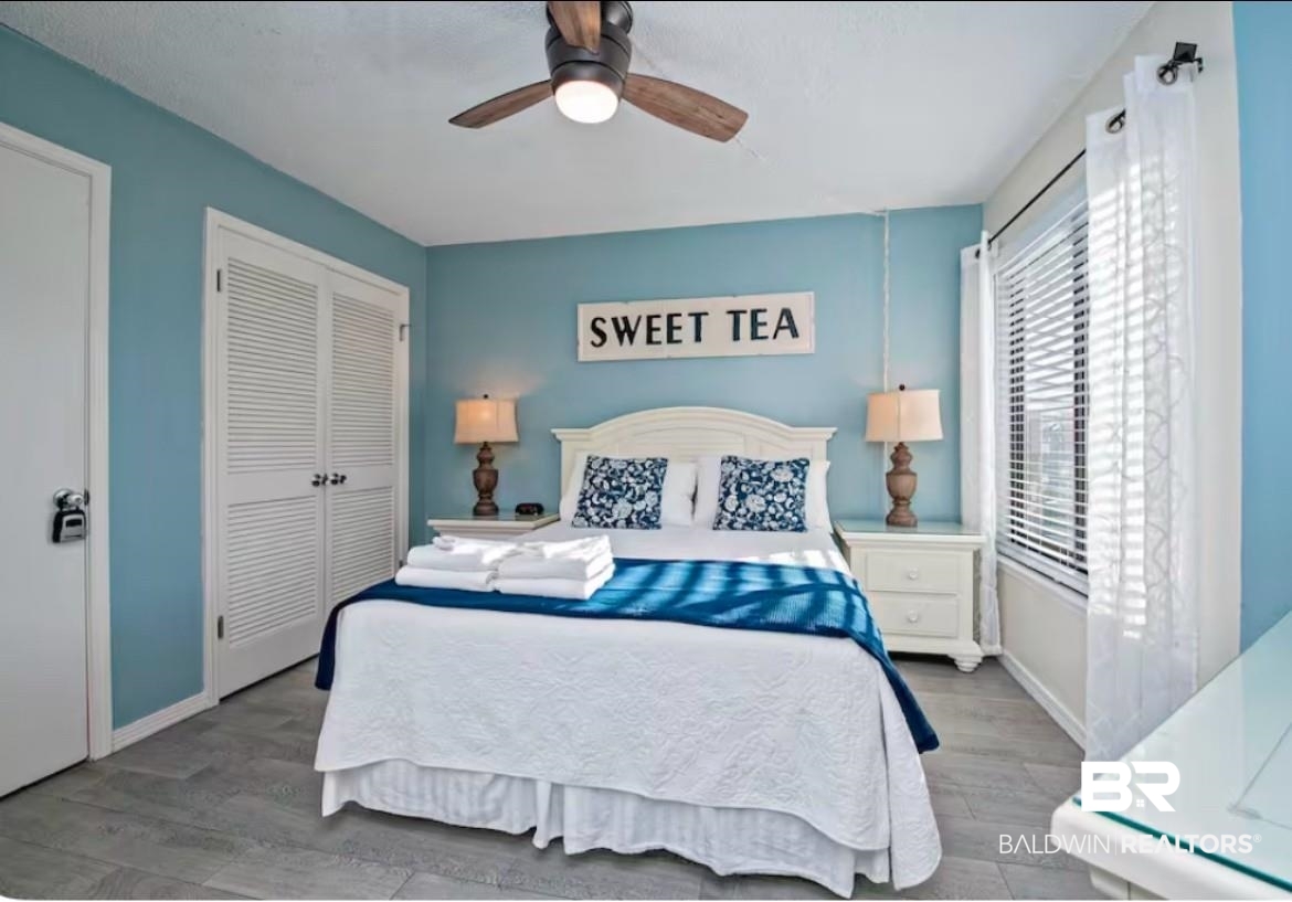 497 Plantation Road, Unit 1156 Gulf Shores, AL 36542 - Photo 11 of 28 Bedroom featuring ceiling fan, light wood-type flooring, and a closet
