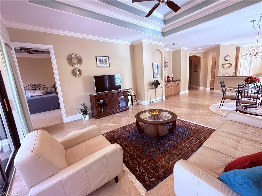 7543 Moorgate Point Way Naples, FL 34113 - Photo 11 of 31 a living room with furniture and a flat screen tv