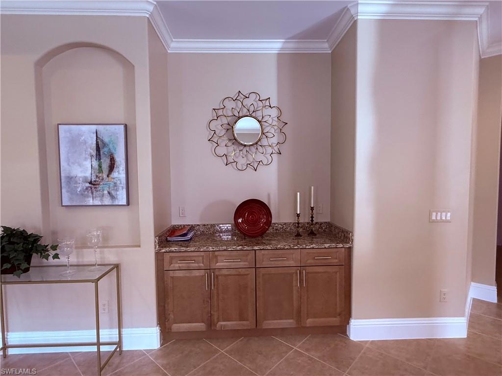 7543 Moorgate Point Way Naples, FL 34113 - Photo 15 of 31 a living room with furniture and a mirror