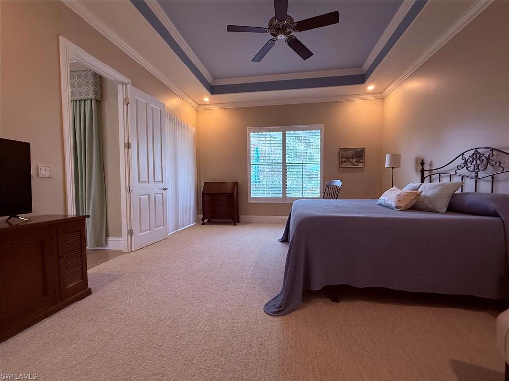 7543 Moorgate Point Way Naples, FL 34113 - Photo 21 of 31 a bedroom with a bed and a chandelier