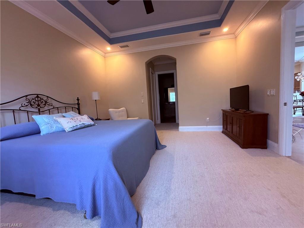 7543 Moorgate Point Way Naples, FL 34113 - Photo 22 of 31 a bedroom with a bed and a flat screen tv