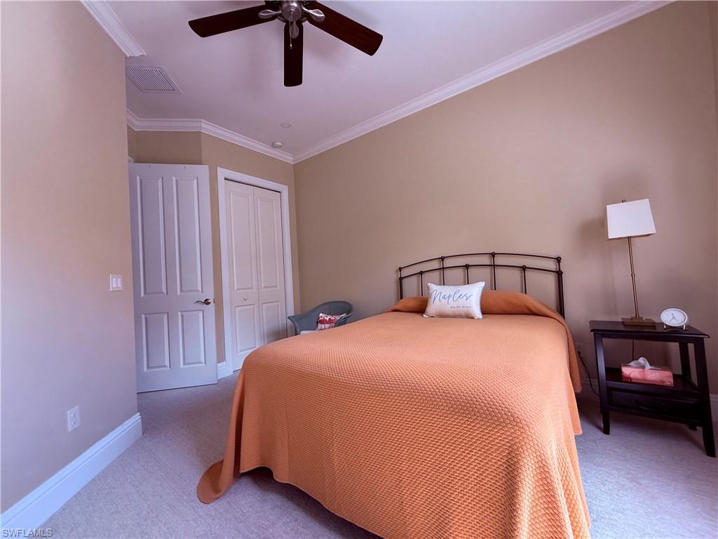 7543 Moorgate Point Way Naples, FL 34113 - Photo 26 of 31 a bedroom with a bed and closet