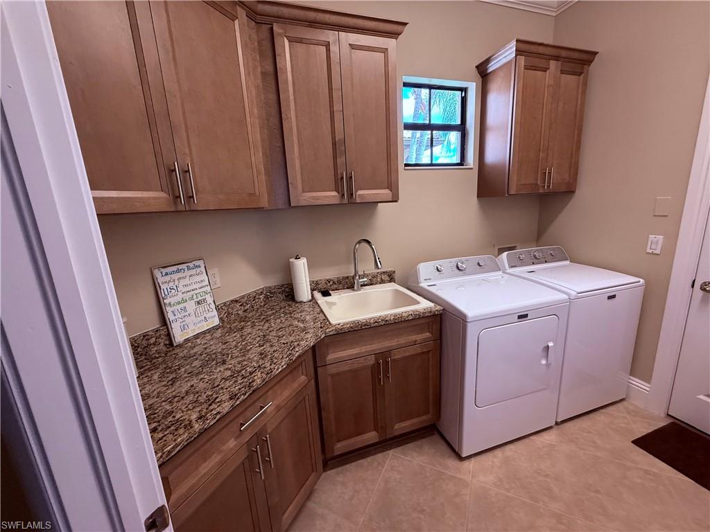 7543 Moorgate Point Way Naples, FL 34113 - Photo 29 of 31 a utility room with dryer and washer