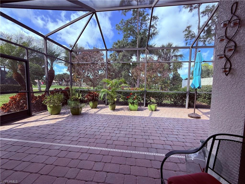 7543 Moorgate Point Way Naples, FL 34113 - Photo 4 of 31 a view of a patio with table and chairs potted plants
