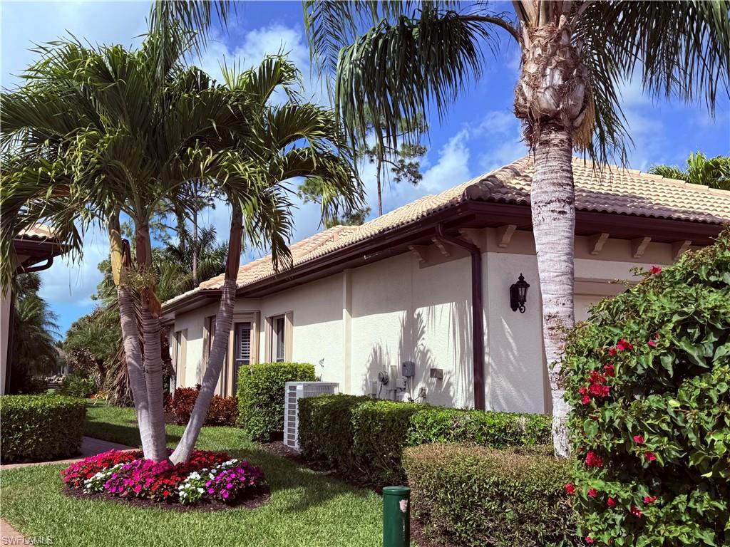 7543 Moorgate Point Way Naples, FL 34113 - Photo 6 of 31 a front view of a house with garden
