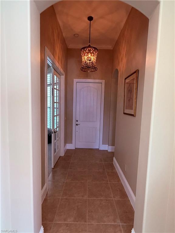 7543 Moorgate Point Way Naples, FL 34113 - Photo 9 of 31 a view of a hallway to a bedroom