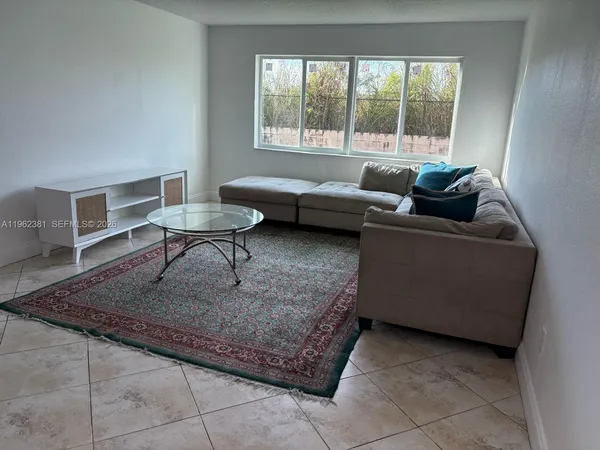 a living room with furniture and a rug