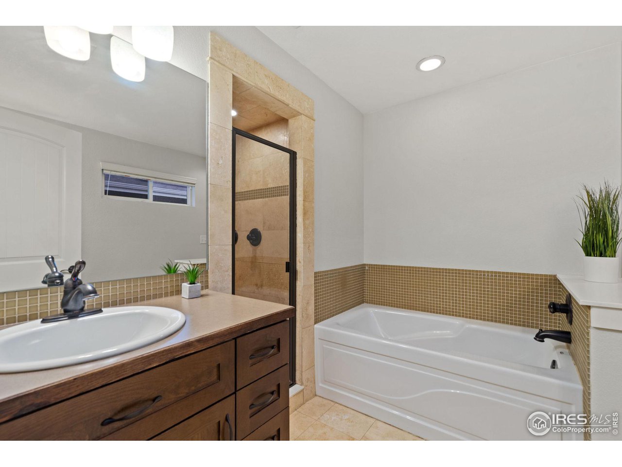 2263 Bellwether Lane Fort Collins, CO 80521 - Photo 19 of 40 a bathroom with a tub sink and mirror