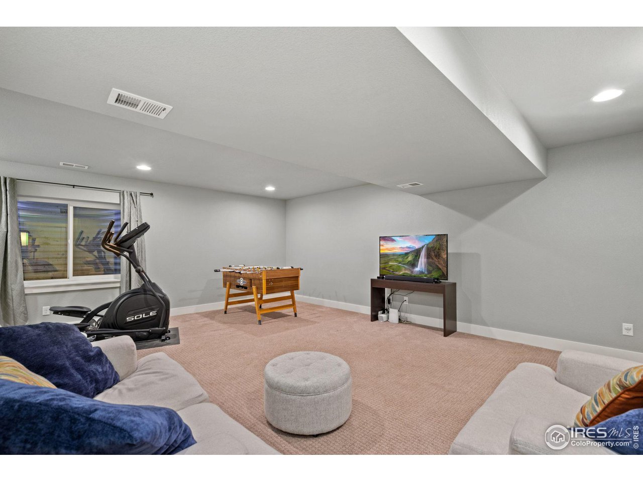 2263 Bellwether Lane Fort Collins, CO 80521 - Photo 28 of 40 a living room with furniture and a gym equipment