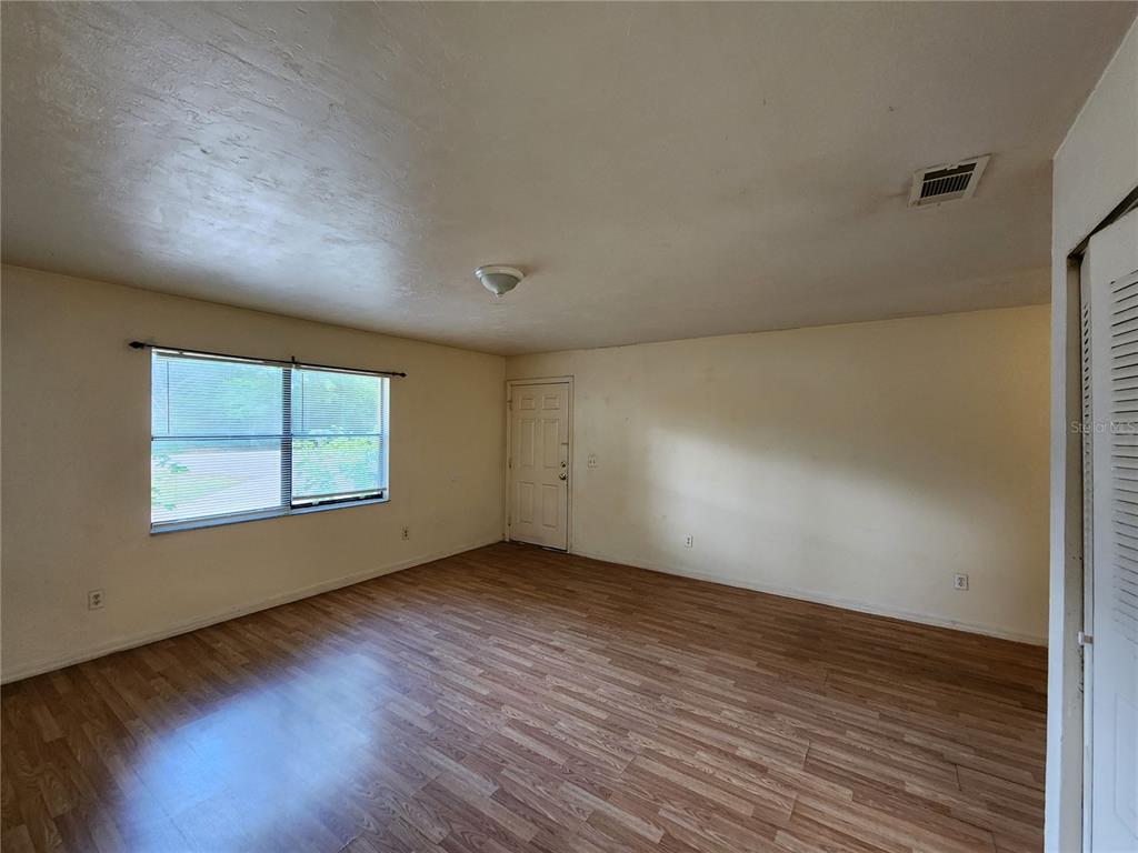 4021 Southwest 37 Street, Unit C Gainesville, FL 32608 - Photo 11 of 25 an empty room with wooden floor and windows