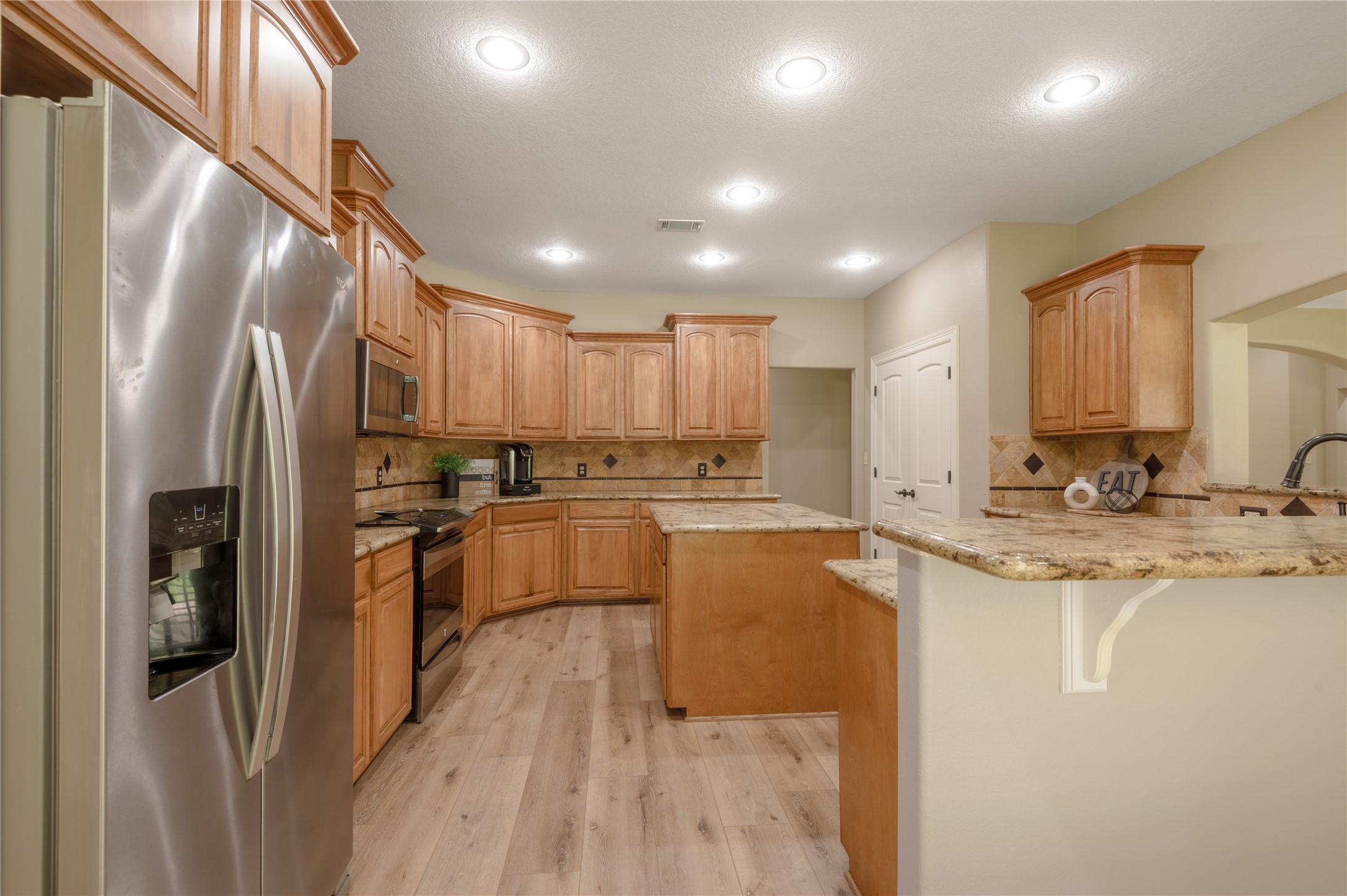 3134 Nursery Road Livingston, TX 77351 - Photo 14 of 50 a kitchen with stainless steel appliances granite countertop a refrigerator a sink a stove and a refrigerator