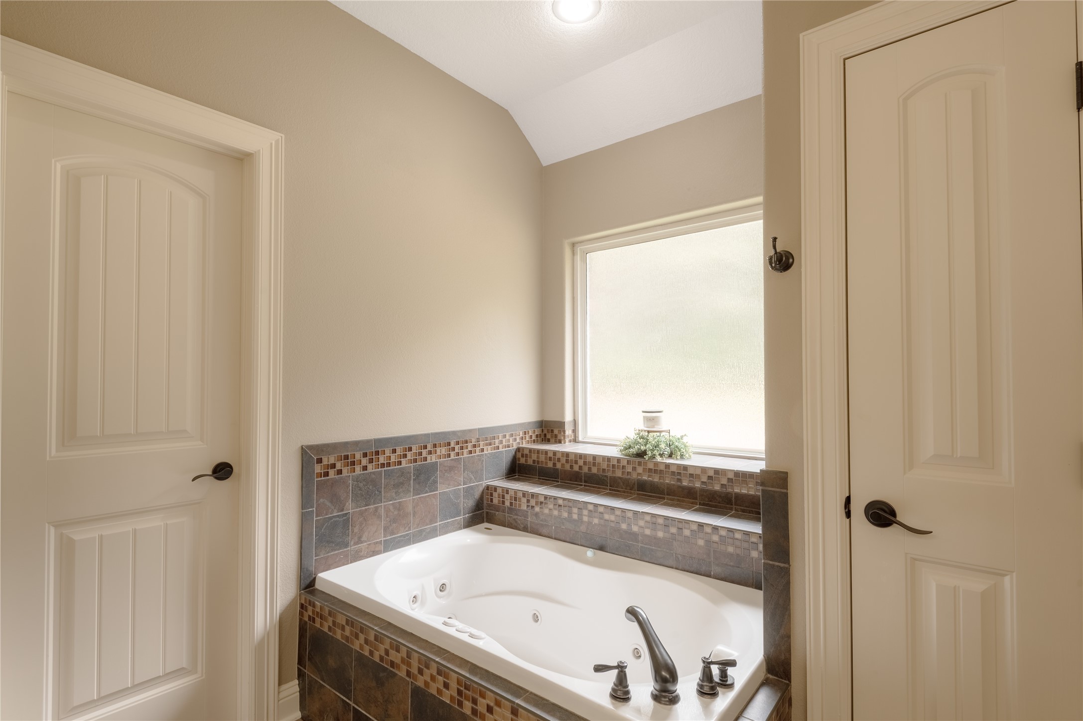 3134 Nursery Road Livingston, TX 77351 - Photo 23 of 50 a bathroom with a tub and a window