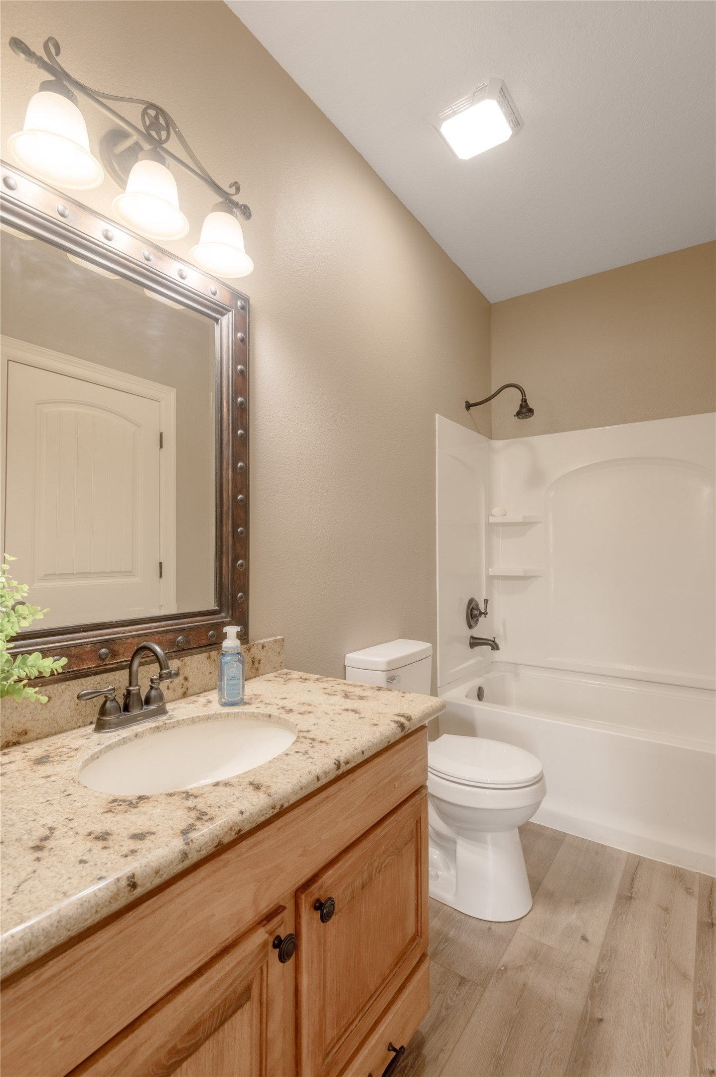 3134 Nursery Road Livingston, TX 77351 - Photo 27 of 50 a bathroom with a granite countertop sink a toilet and a mirror