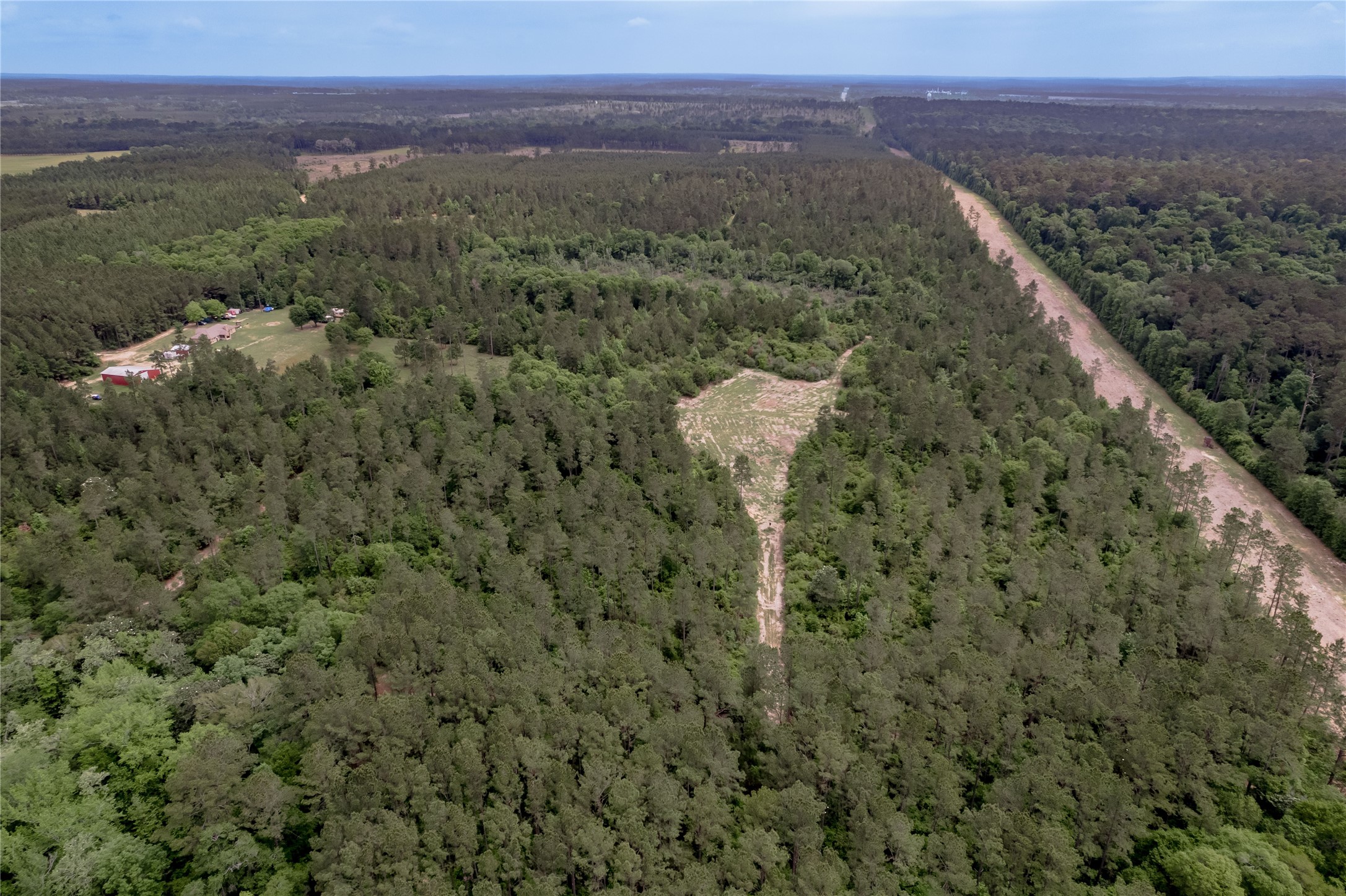 3134 Nursery Road Livingston, TX 77351 - Photo 45 of 50 This is an overview shot of the back of the property. The cleared area in the middle is great for setting up hunting blinds and game cameras. Just to the top of that spot is the Mayhaw Pond. The cleared "road" to the right is the pipeline easement and beyond that is the "Big Thicket" that holds the Alabama Coushatta Reservation.