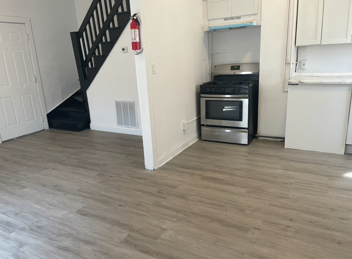 17104 Wentworth Avenue, Unit 6 Lansing, IL 60438 - Photo 2 of 8 a view of kitchen and hallway with an empty room