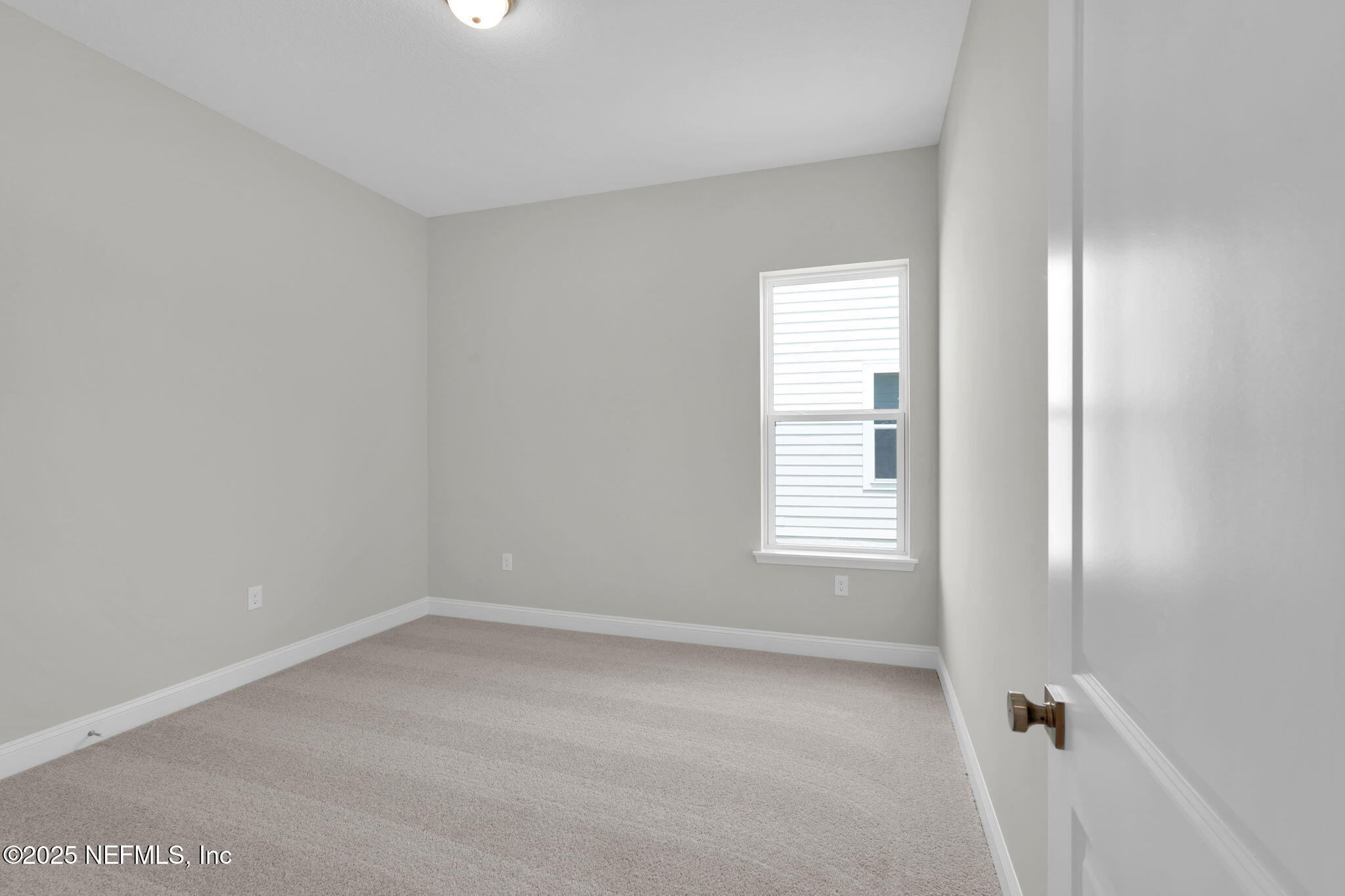 440 Slash Pine Place Yulee, FL 32097 - Photo 12 of 38 a view of an empty room with a window