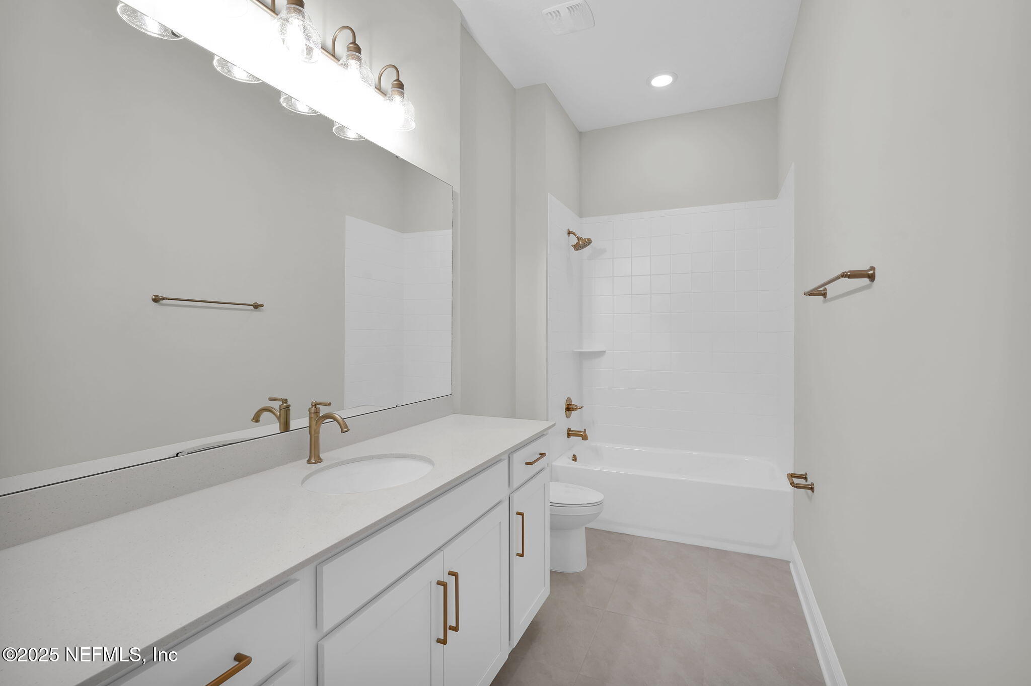 440 Slash Pine Place Yulee, FL 32097 - Photo 13 of 38 a bathroom with a double vanity sink a toilet and a bathtub