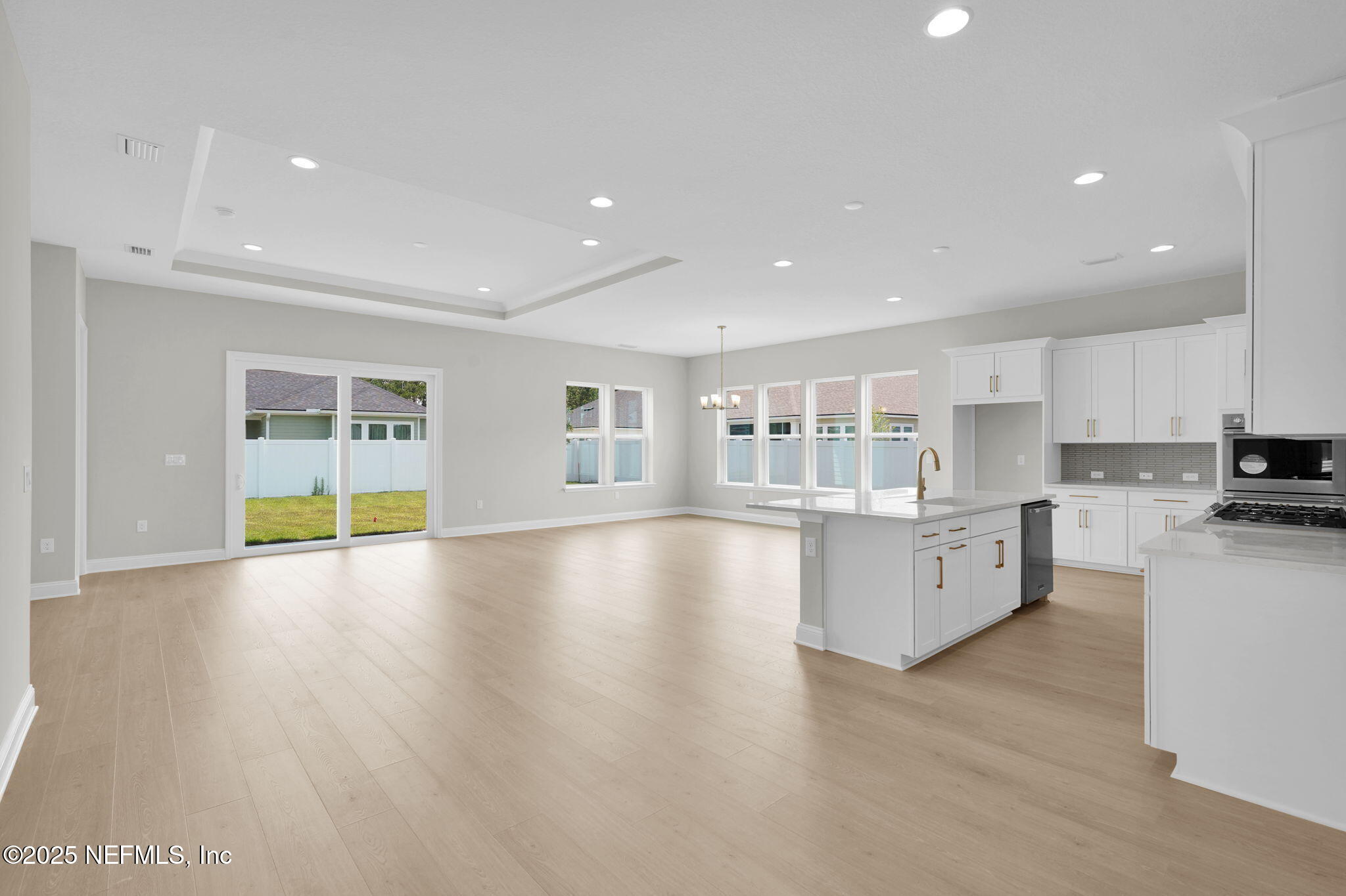 440 Slash Pine Place Yulee, FL 32097 - Photo 14 of 38 a view of an empty room with window and wooden floor