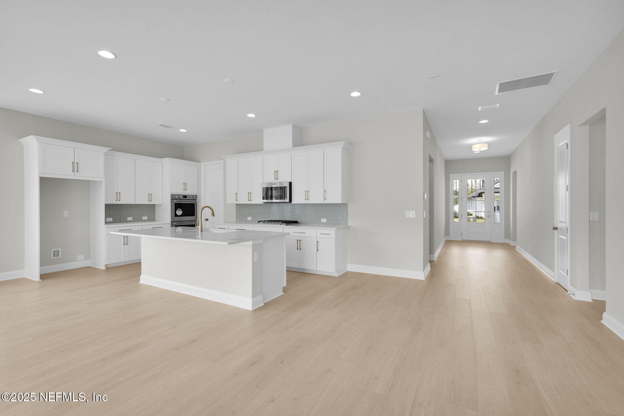 440 Slash Pine Place Yulee, FL 32097 - Photo 15 of 38 a big room with stainless steel appliances kitchen island a white counter space and a refrigerator
