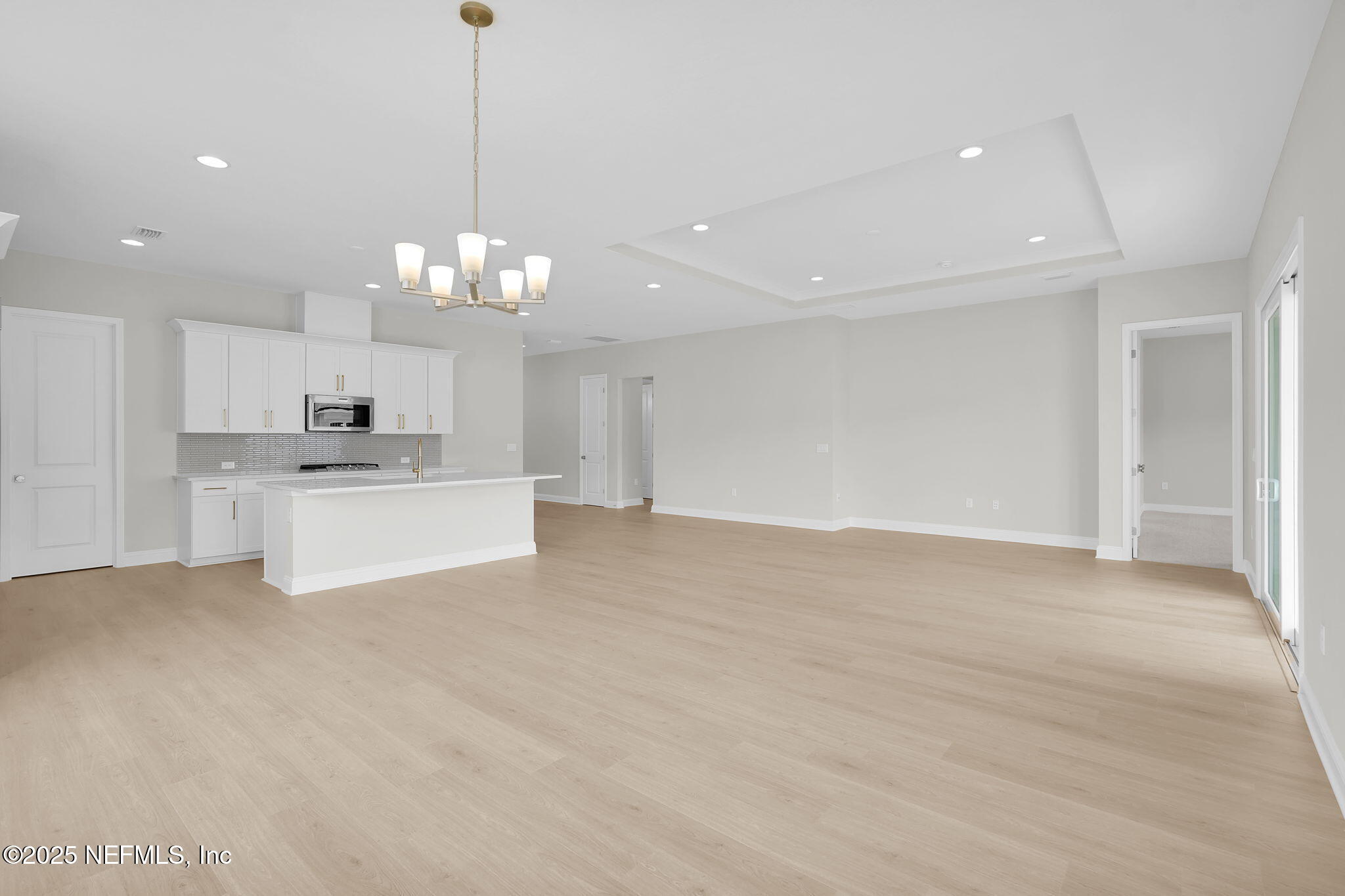 440 Slash Pine Place Yulee, FL 32097 - Photo 23 of 38 a view of a kitchen with a sink cabinets and a chandelier