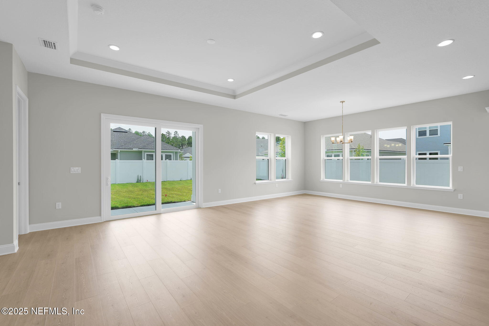 440 Slash Pine Place Yulee, FL 32097 - Photo 25 of 38 a view of an empty room with wooden floor and a window