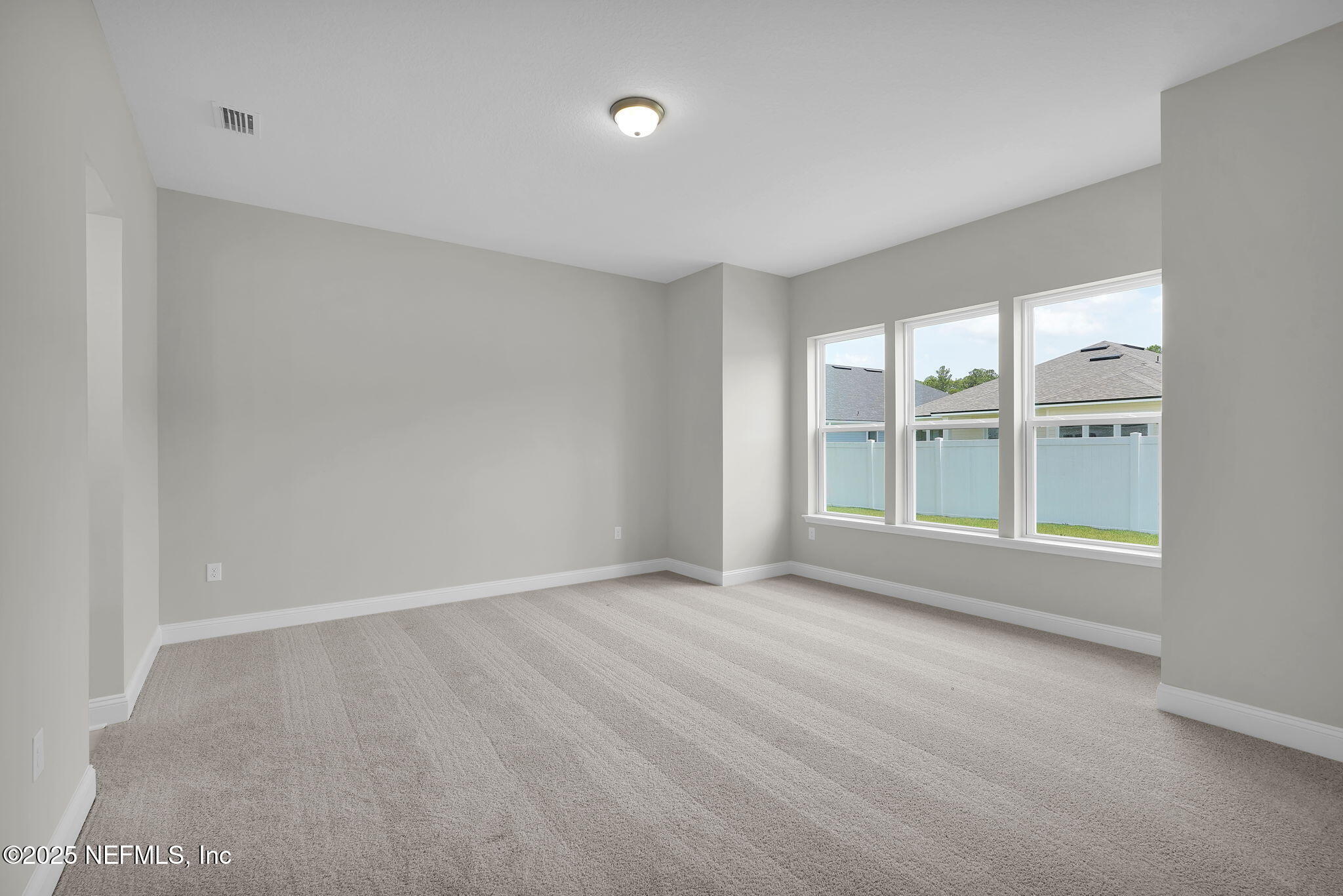 440 Slash Pine Place Yulee, FL 32097 - Photo 26 of 38 wooden floor in an empty room with a window