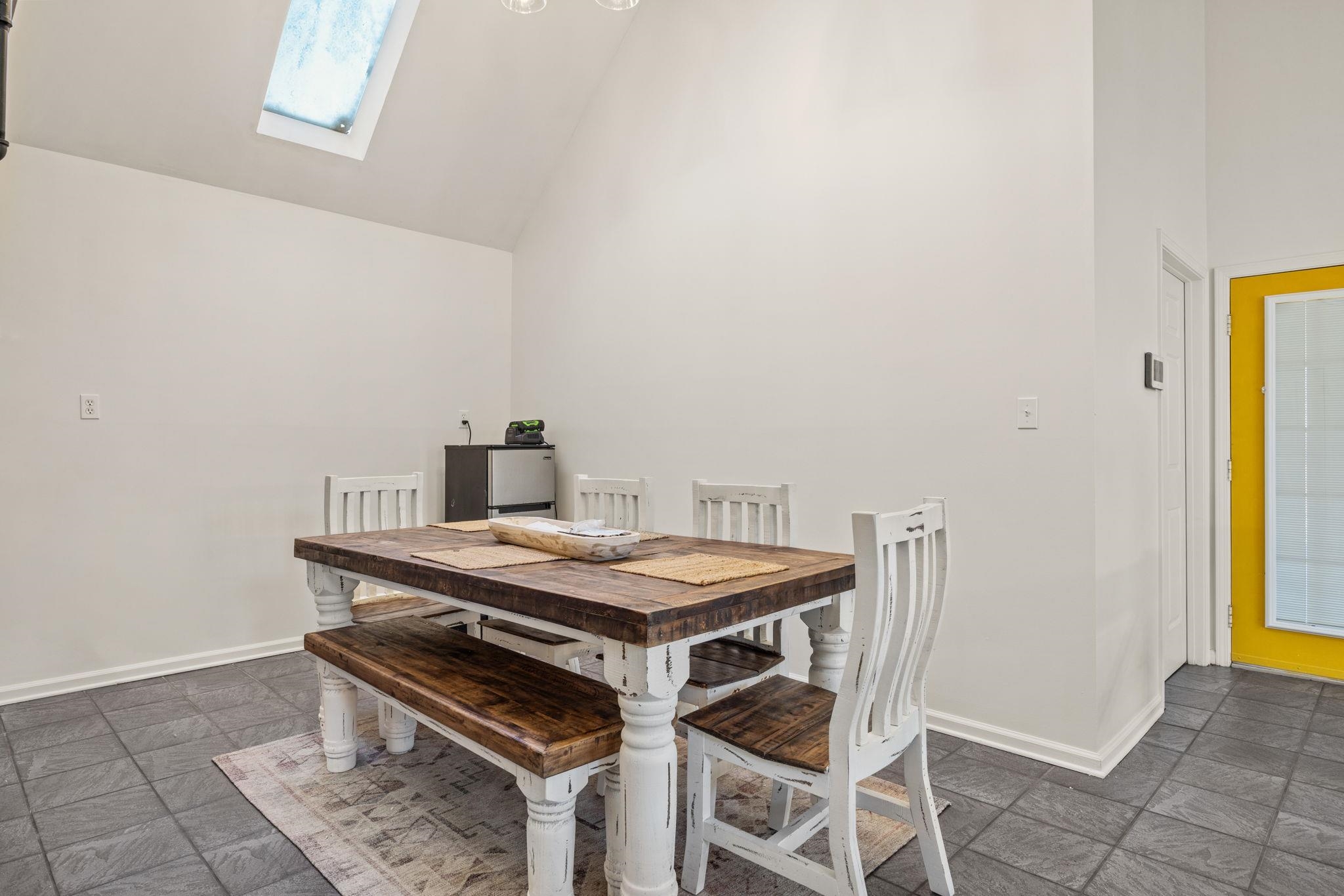 113 Horseshoe Lake Road Saltillo, MS 38866 - Photo 12 of 39 Dining area with high vaulted ceiling and a skylight