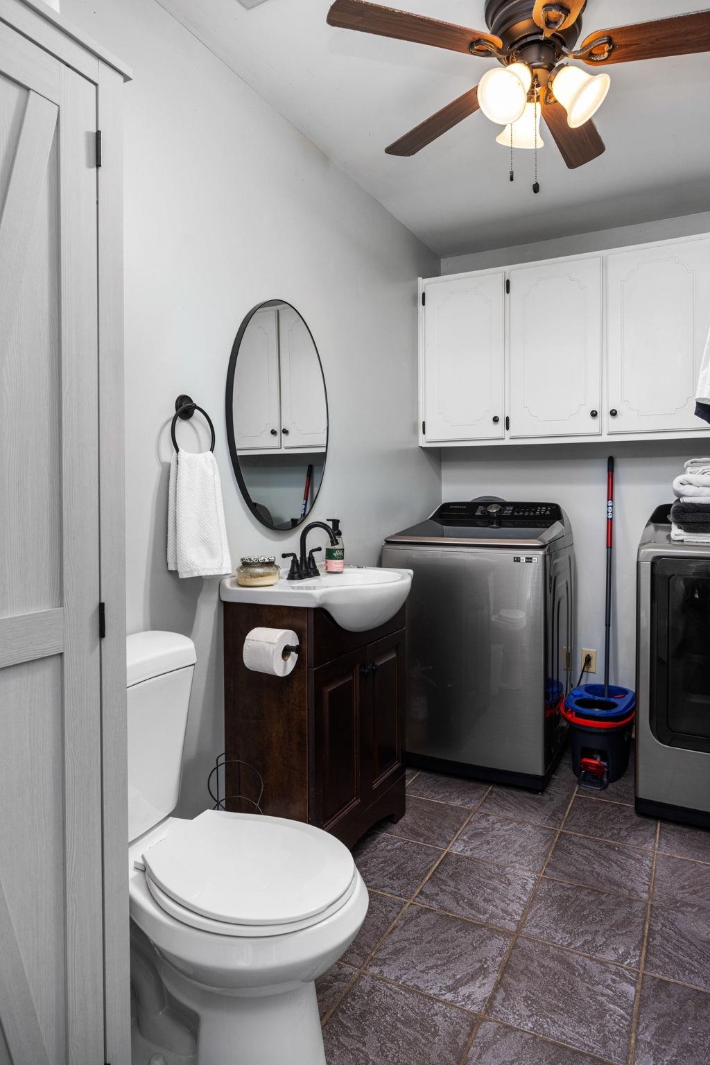 113 Horseshoe Lake Road Saltillo, MS 38866 - Photo 23 of 39 Bathroom with vanity, toilet, ceiling fan, and washing machine and clothes dryer