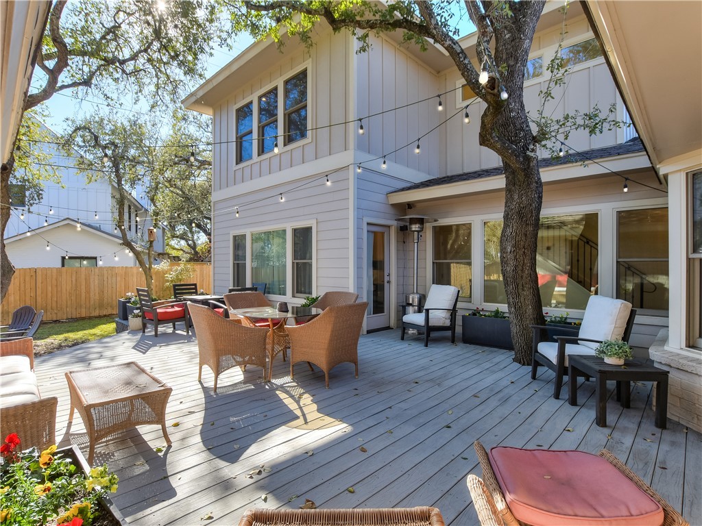 4107 Tablerock Drive Austin, TX 78731 - Photo 1 of 1 a view of a patio with couches table and chairs under an umbrella