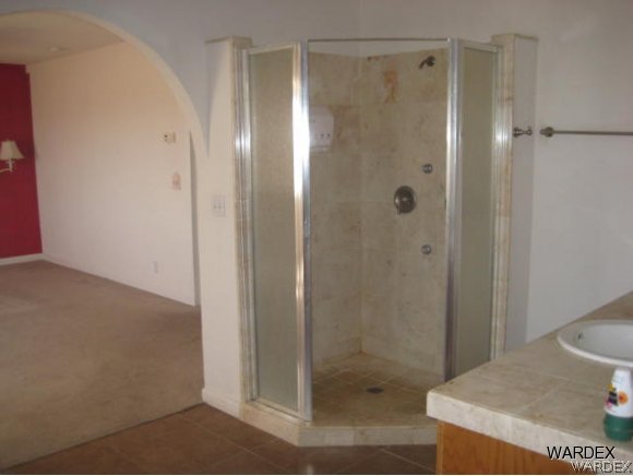 3437 Bacobi Road Golden Valley, AZ 86413 - Photo 13 of 17 a bathroom with a shower and a sink