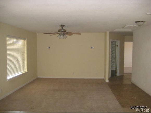 3437 Bacobi Road Golden Valley, AZ 86413 - Photo 10 of 17 wooden floor in an empty room with a window