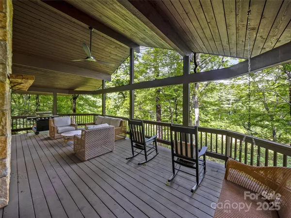 a view of roof deck with chairs and wooden floor