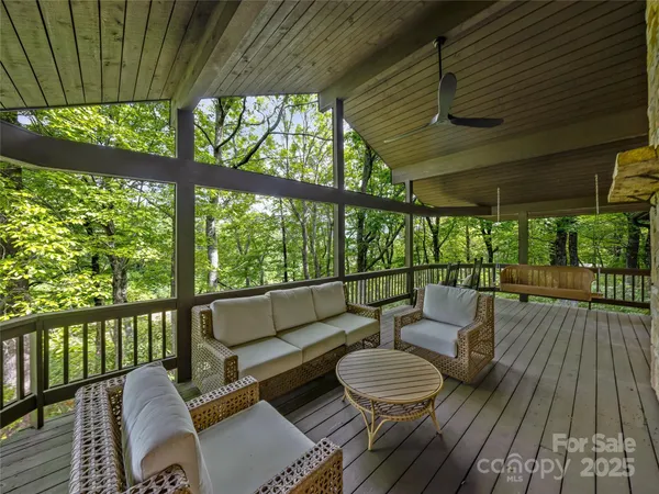 a balcony with wooden floor and outdoor seating