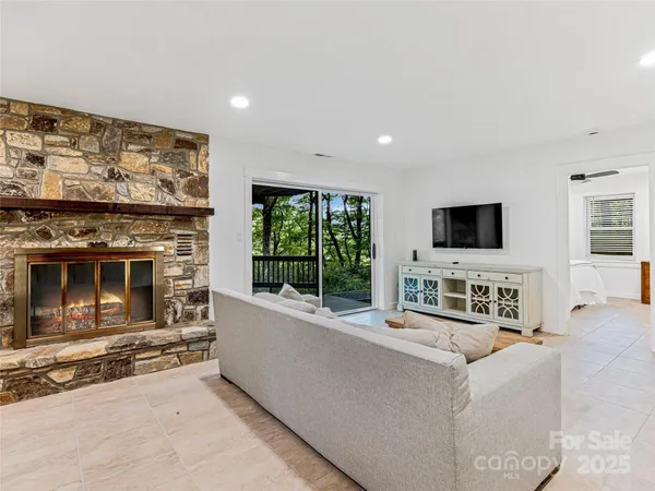 a living room with fireplace furniture and a flat screen tv