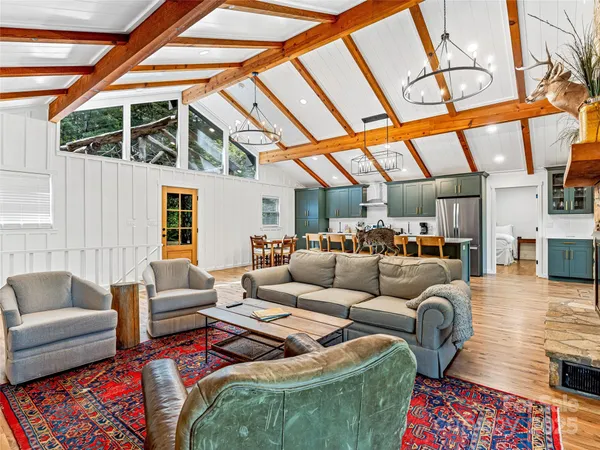 a living room with furniture a fireplace and next to a window