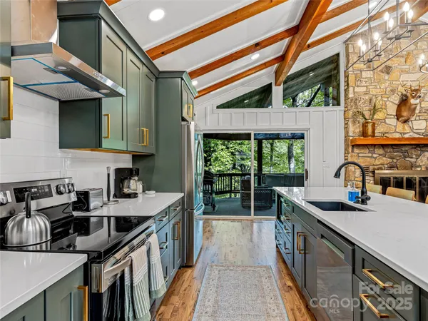 a kitchen with granite countertop a sink a counter top space and cabinets