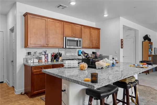 a kitchen with sink a stove and chairs