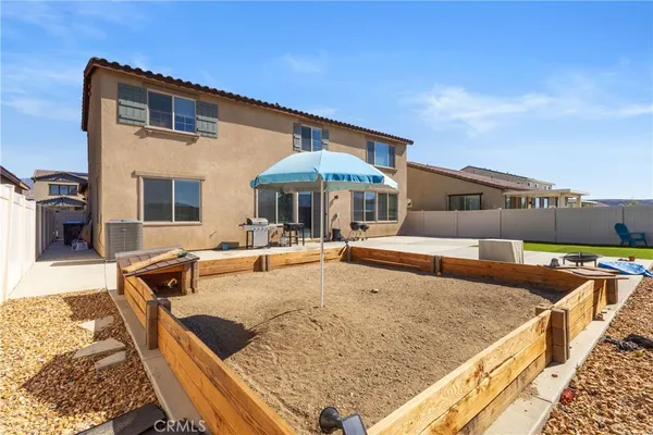 a swimming pool with outdoor seating and barbeque oven