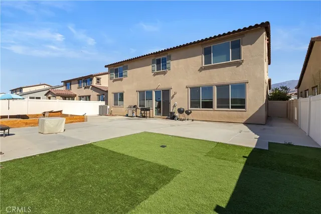a view of a house with a backyard porch and sitting area