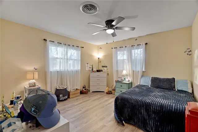 a bedroom with furniture and a book shelf