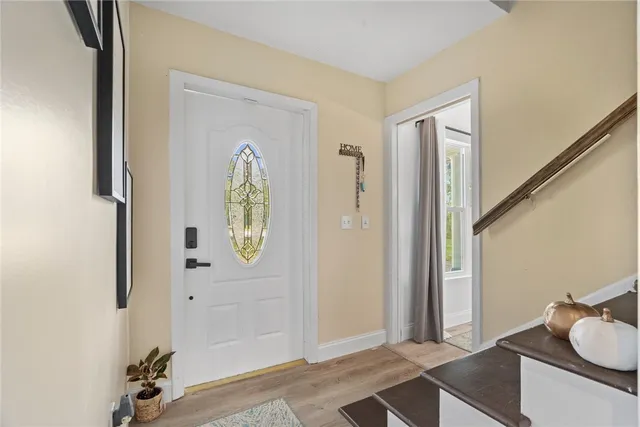 a view of an entryway with wooden floor
