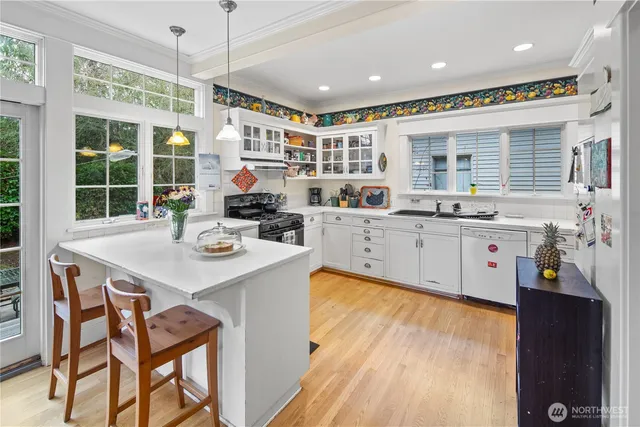a kitchen with a sink window and cabinets