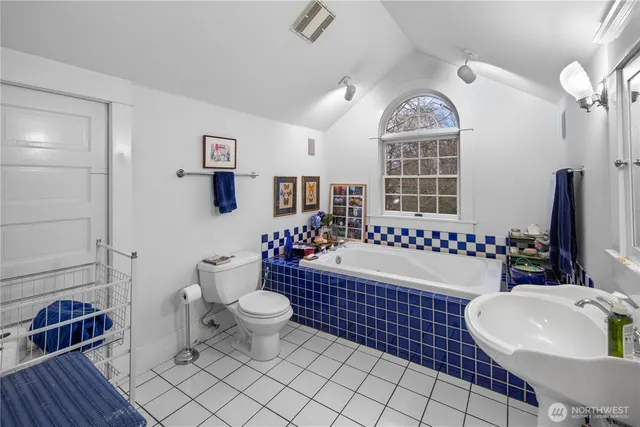 a bathroom with a sink toilet a mirror and shower