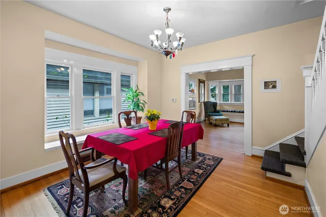 a view of a dining room with furniture and wooden floor