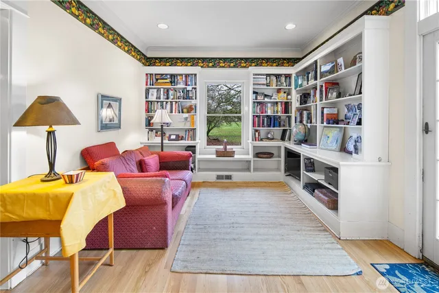 a reading room with furniture and a book shelf