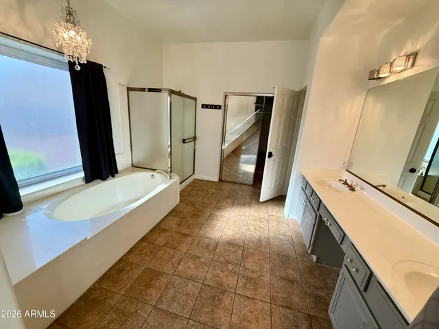 a bathroom with a tub sink and a mirror