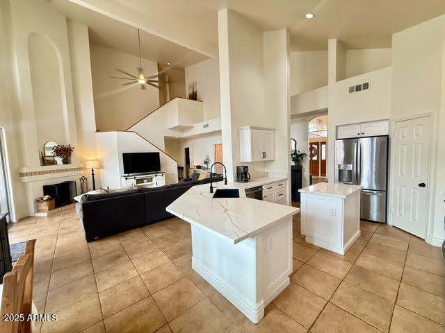 6743 East Tyndall Circle Mesa, AZ 85215 - Photo 11 of 27 a large white kitchen with a large window and white cabinets