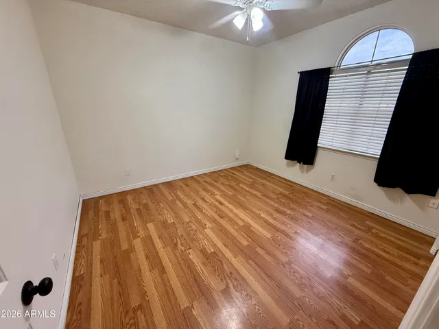 a view of a room with wooden floor and white walls