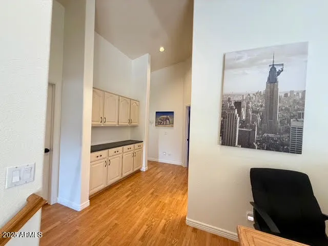a kitchen with granite countertop a refrigerator and a stove top oven